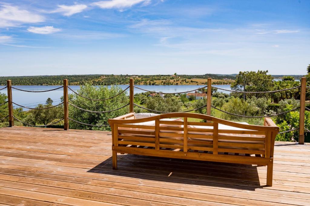 a wooden bench sitting on top of a wooden deck at Monte da Cegonha Preta in Montargil