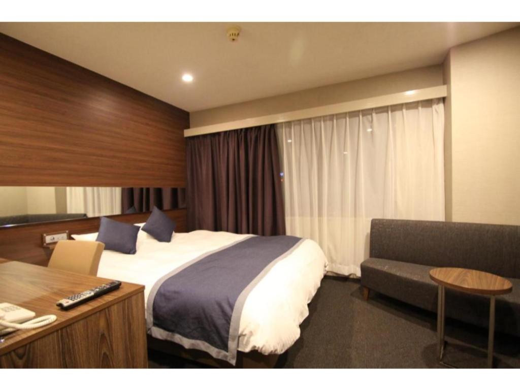 ein Hotelzimmer mit einem Bett und einem Schreibtisch in der Unterkunft Hotel Il Credo Gifu - Vacation STAY 84603 in Gifu