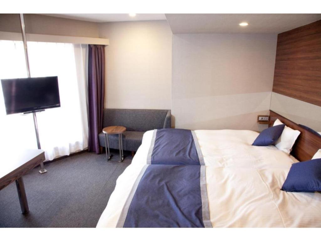 A bed or beds in a room at Hotel Il Credo Gifu - Vacation STAY 84631