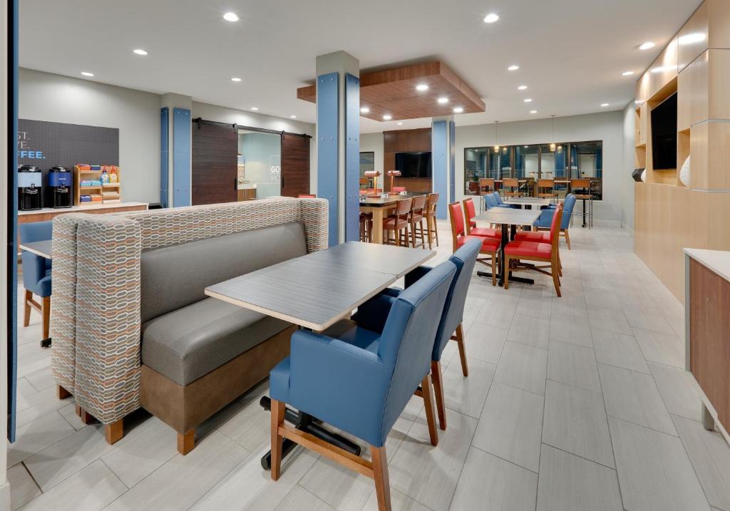 a dining room with a table and chairs at Holiday Inn Express & Suites San Antonio NW near SeaWorld by IHG in San Antonio