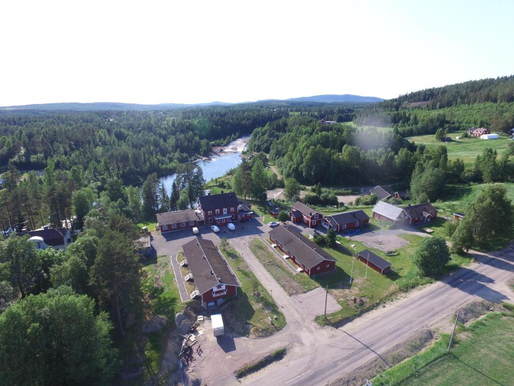 uma vista aérea de um alojamento de turismo selvagem com um rio e árvores em Björnforsens Turist & Konferenshotell, Nära Husum, Örnsköldsvik em Björna