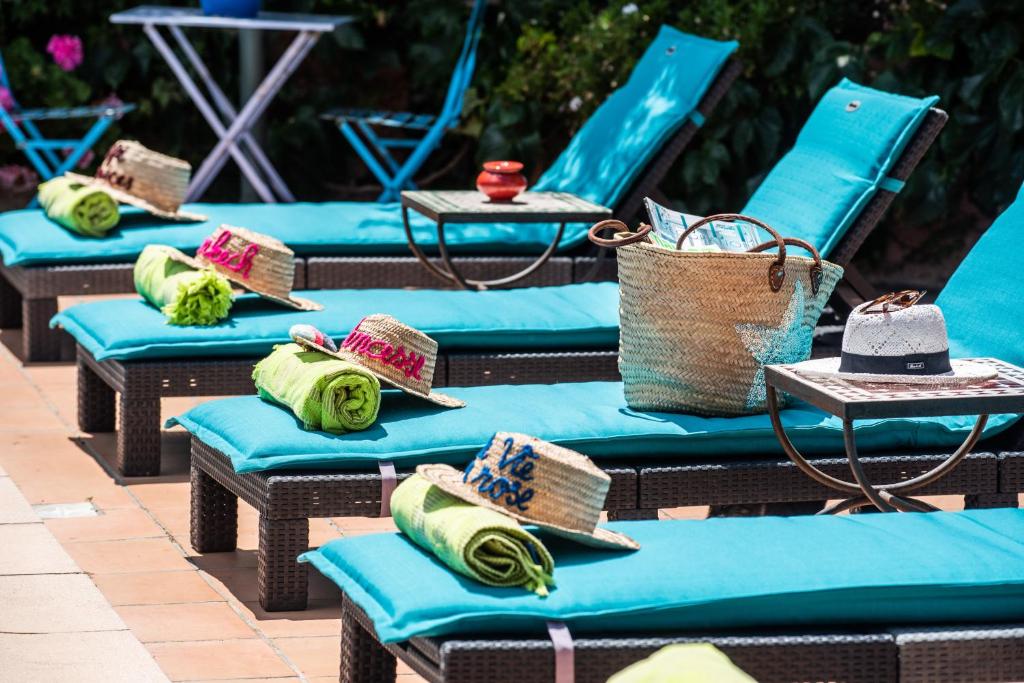 a row of blue chairs with hats on them at La Beytina - B&B and Apartment in Pennautier