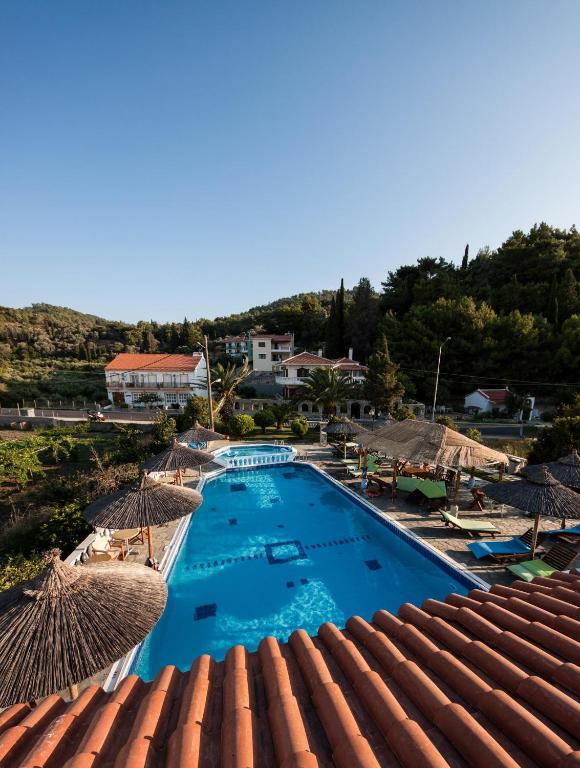 a view of a swimming pool with umbrellas on a roof at Kokkari Beach Hotel in Kokkari