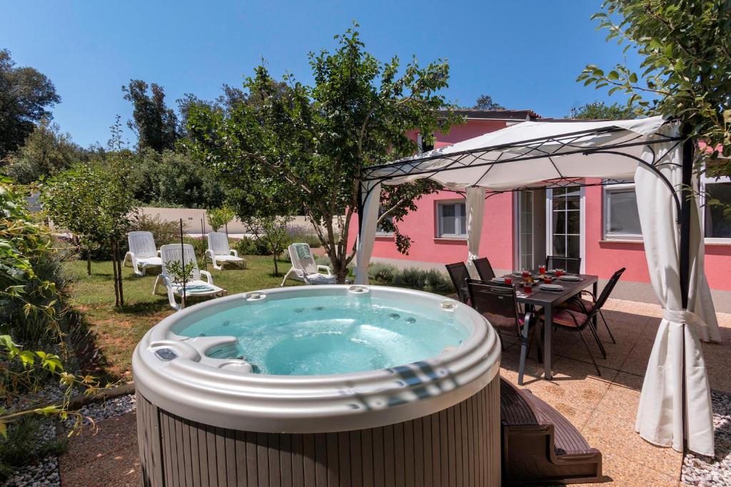 a hot tub in the backyard of a house at House Bumbiste 1703 in Banjole