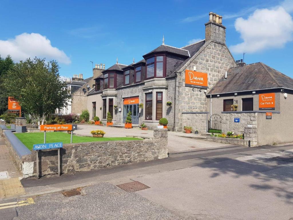 a building with a sign in front of it at The Dunavon in Dyce