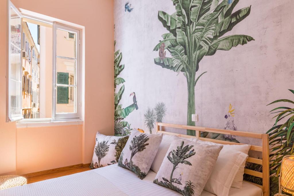 a bedroom with a bed with a plant mural on the wall at Casa Tropicana in Corfu
