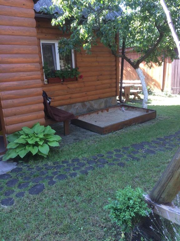 a backyard with a bench and a house at садиба Подвір'ячко in Szack