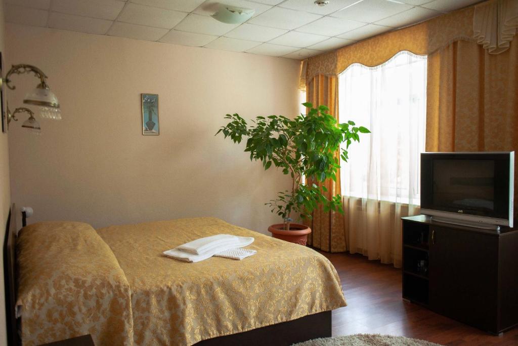 a hospital room with two beds and a tv at Skazka Inn in Yaroslavl