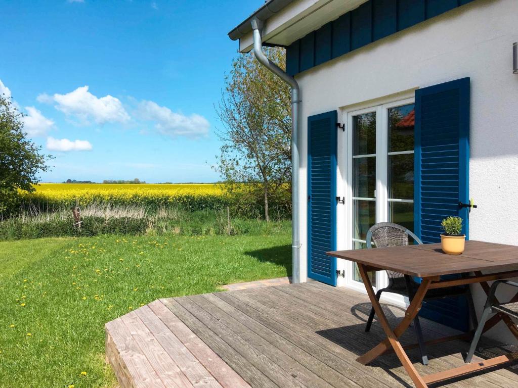 a picnic table on a deck next to a house at Holiday Home Strelasund by Interhome in Altefähr