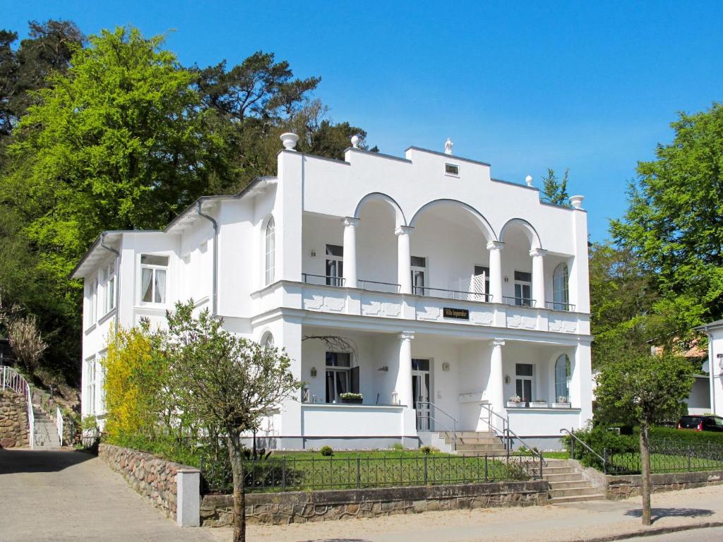 an old white house with trees in front of it at Apartment Villa Imperator by Interhome in Ostseebad Sellin