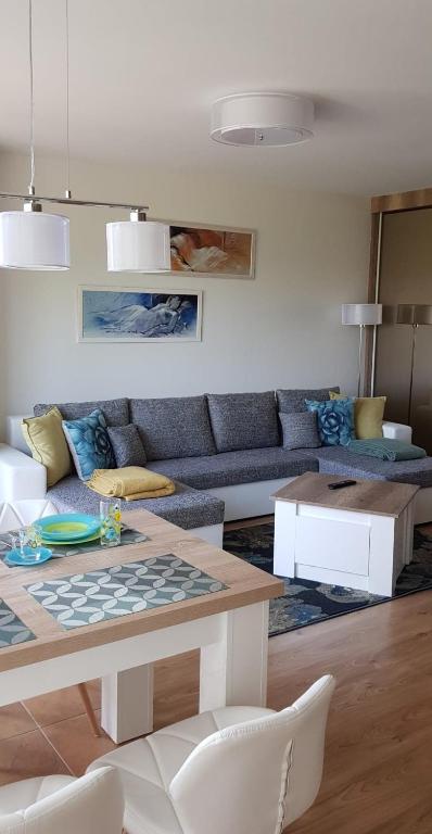 a living room with a couch and a table at Palanga-Smilgu. g. in Palanga