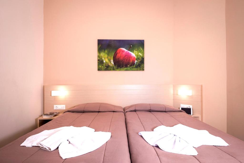 a bedroom with a large bed with two pillows at Atrion Resort Hotel in Agia Marina Nea Kydonias