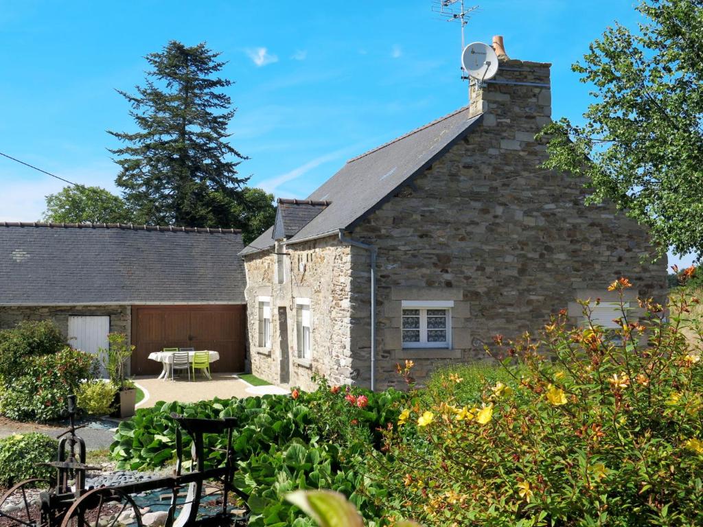 a stone house with a garden in front of it at Holiday Home L'Egven by Interhome in Matignon