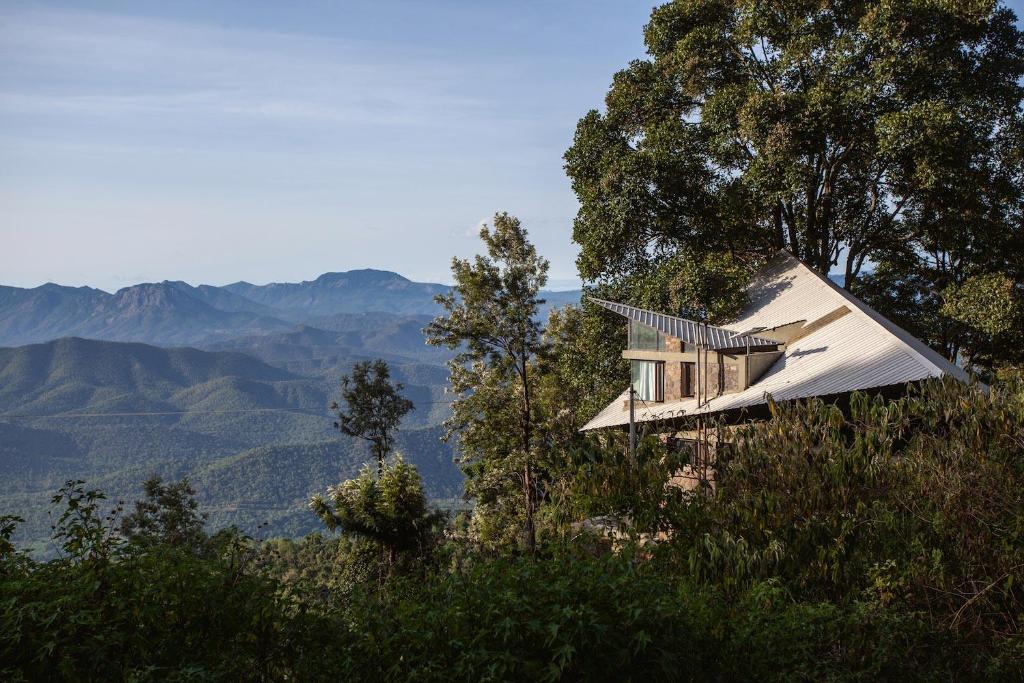 una casa en una colina con vistas a las montañas en O'Land Plantation en Kolakambe