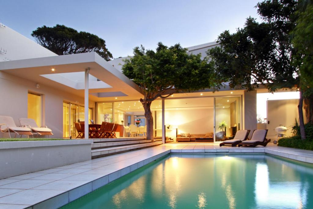 a swimming pool in the backyard of a house at Lion's View Villa & Apartment in Cape Town