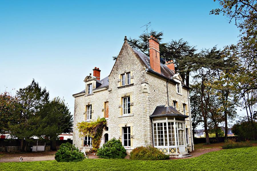 a large white house with a large window at Le Clos Des Ormeaux in Vineuil