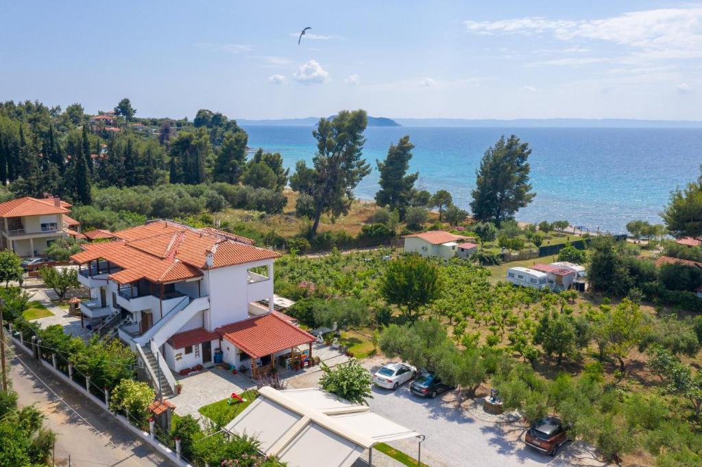 an aerial view of a house and the ocean at Fantasia Studios and Apartments in Neos Marmaras