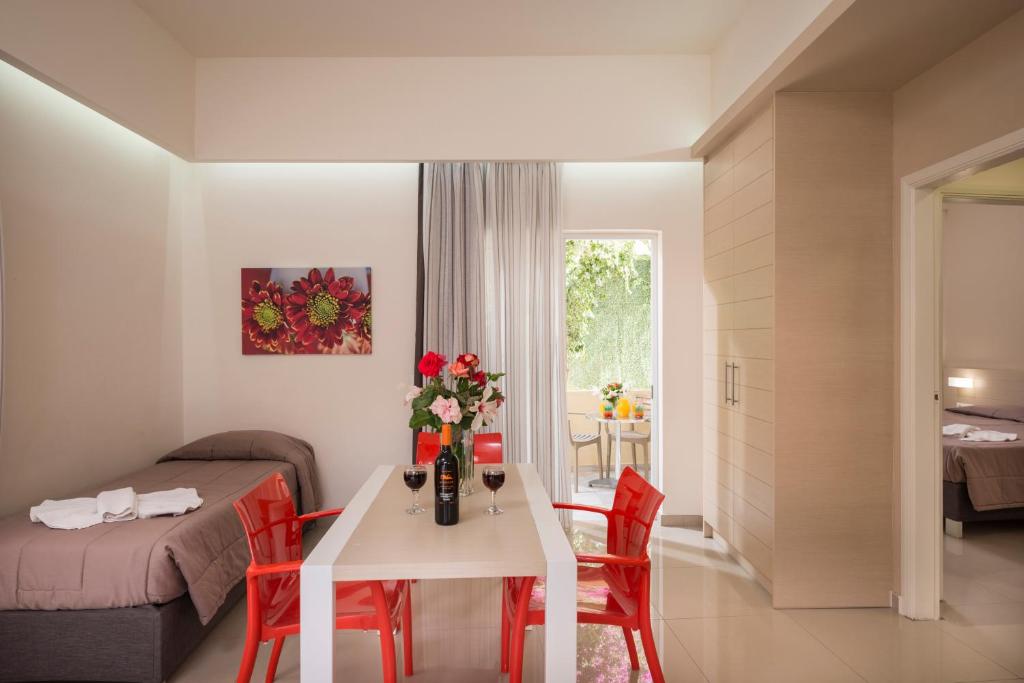 a small room with a table and red chairs at Atrion Resort Hotel in Agia Marina Nea Kydonias