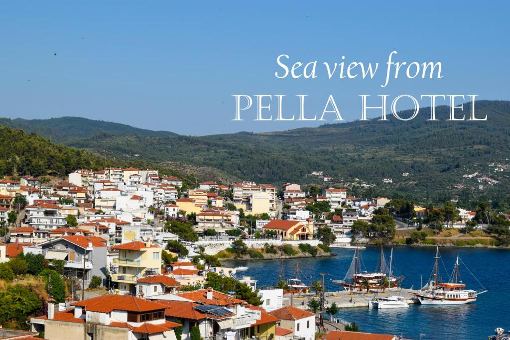 a view of a town with boats in the water at Pella Hotel - new in Neos Marmaras