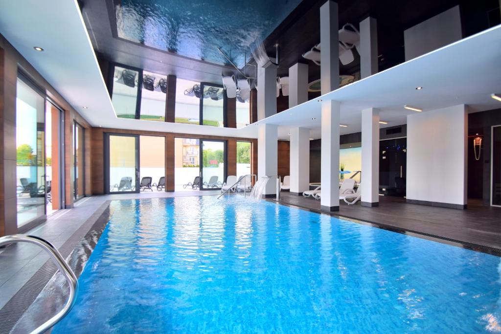 a pool in a hotel with a large room at Savana Resort Mielno in Mielno