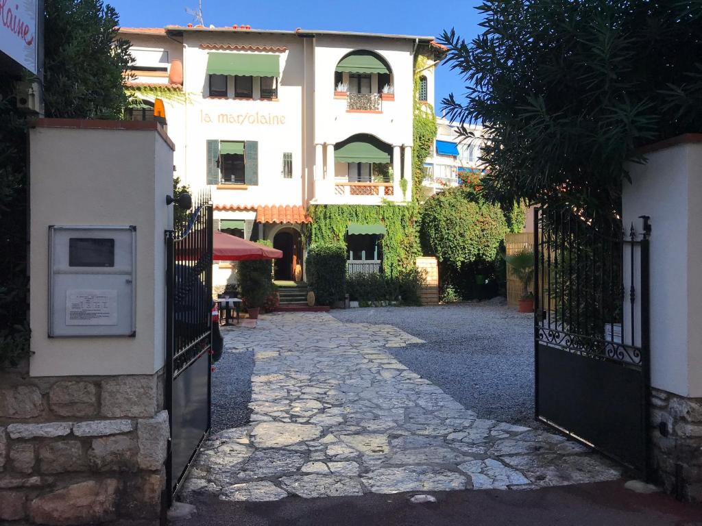 an entrance to a building with a gate at La Marjolaine in Juan-les-Pins