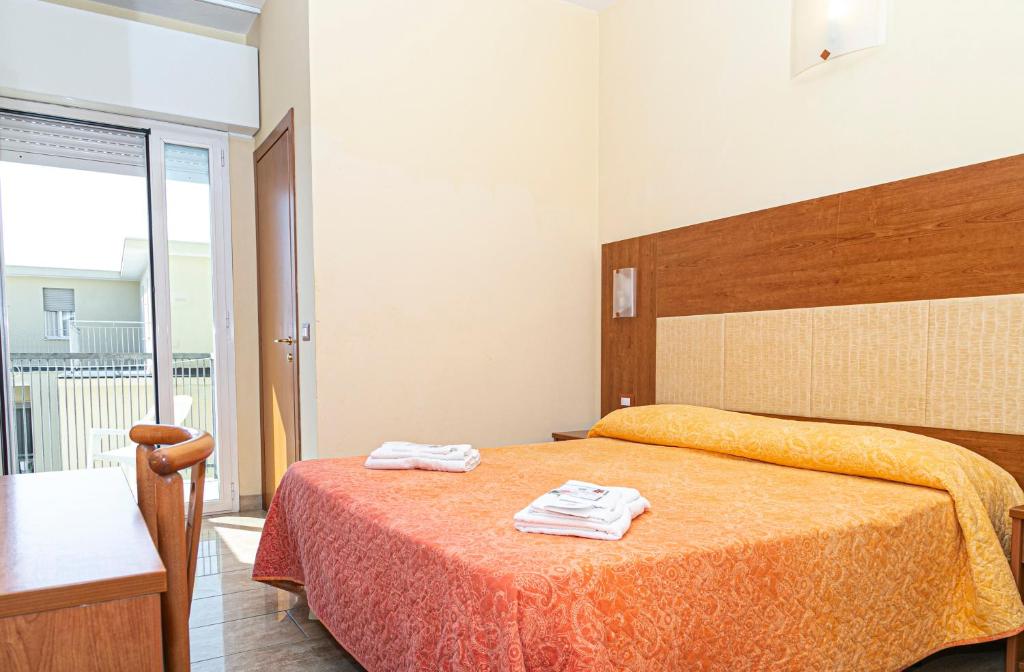 Postel nebo postele na pokoji v ubytování Hotel Ambasciatori