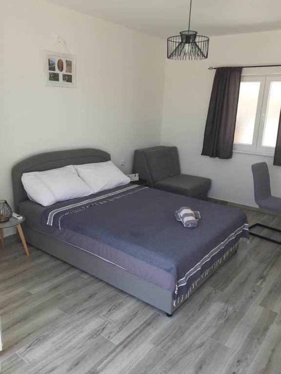 a bedroom with a bed and a couch at Studio Ela in Baška Voda