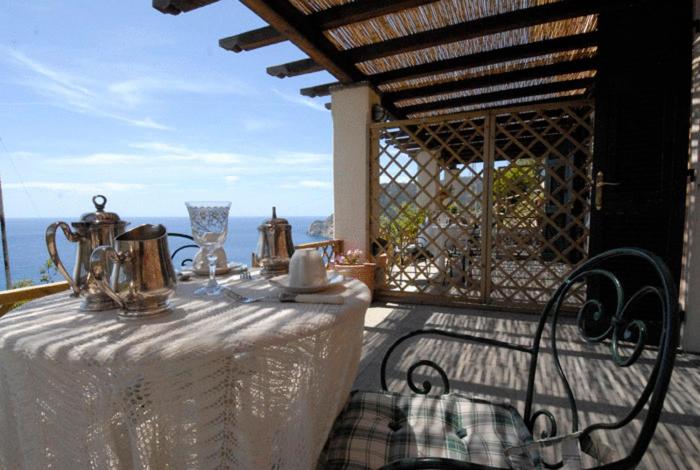 een tafel met een witte tafeldoek op een balkon bij La Serra Sul Mare in Monterosso al Mare