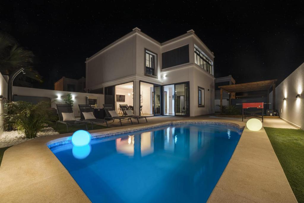 a house with a swimming pool at night at Villa Flamboyan in Yaiza