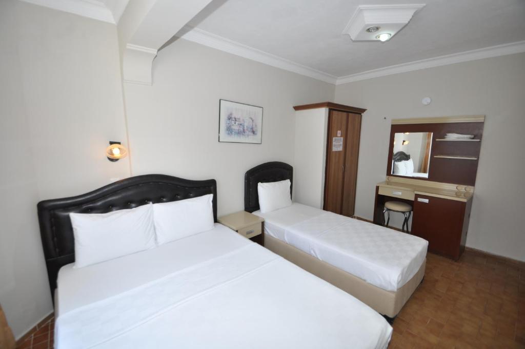 Postel nebo postele na pokoji v ubytování Defne & Zevkim Hotel