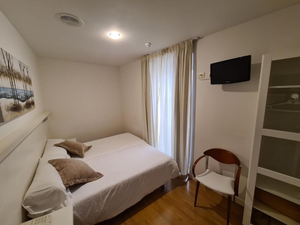 Postel nebo postele na pokoji v ubytování Hotel Jacobeo