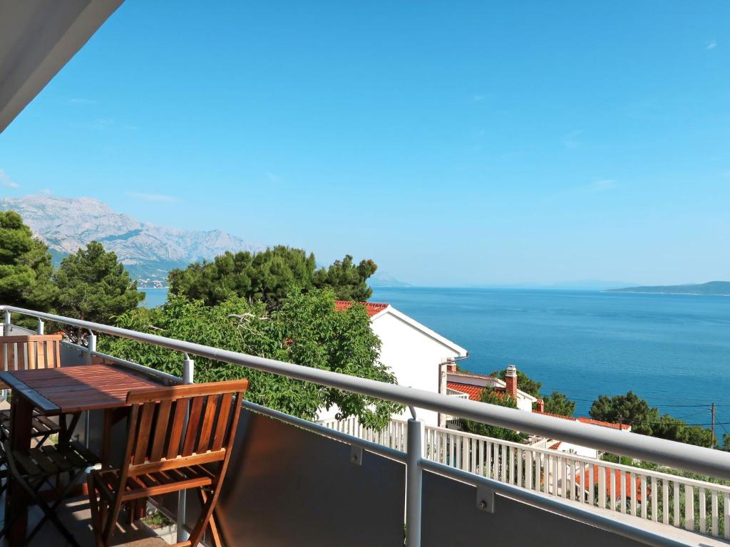 einen Balkon mit einem Tisch und Meerblick in der Unterkunft Apartment Bacic - OMI216 by Interhome in Marusici 