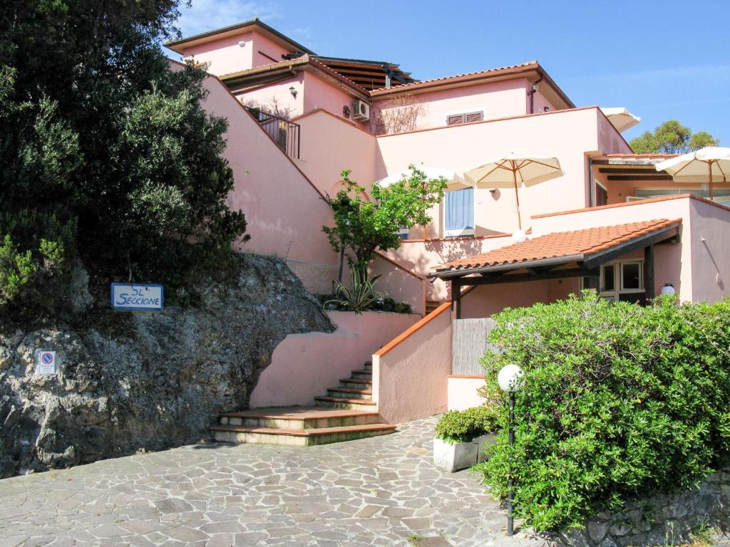 a house with stairs leading up to it at Apartment Il Seccione-1 by Interhome in Portoferraio