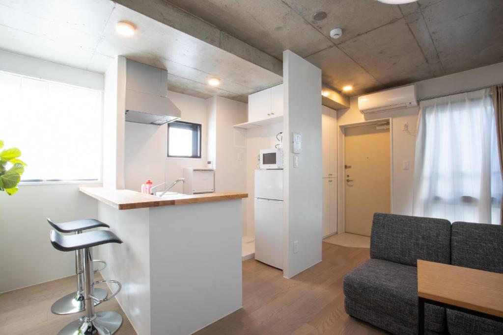 a kitchen and living room with a couch and a table at Tokyo WEST Laffite - Vacation STAY 8297 in Ogikubo