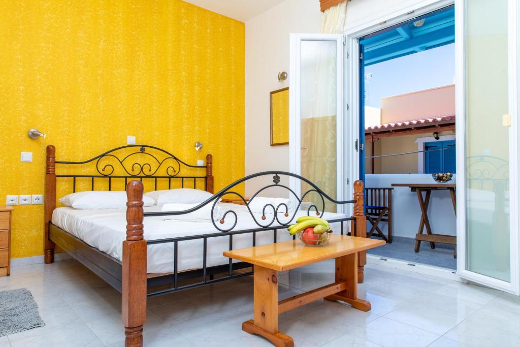 a bedroom with a bed and a table at Studios Marina Naxos in Naxos Chora
