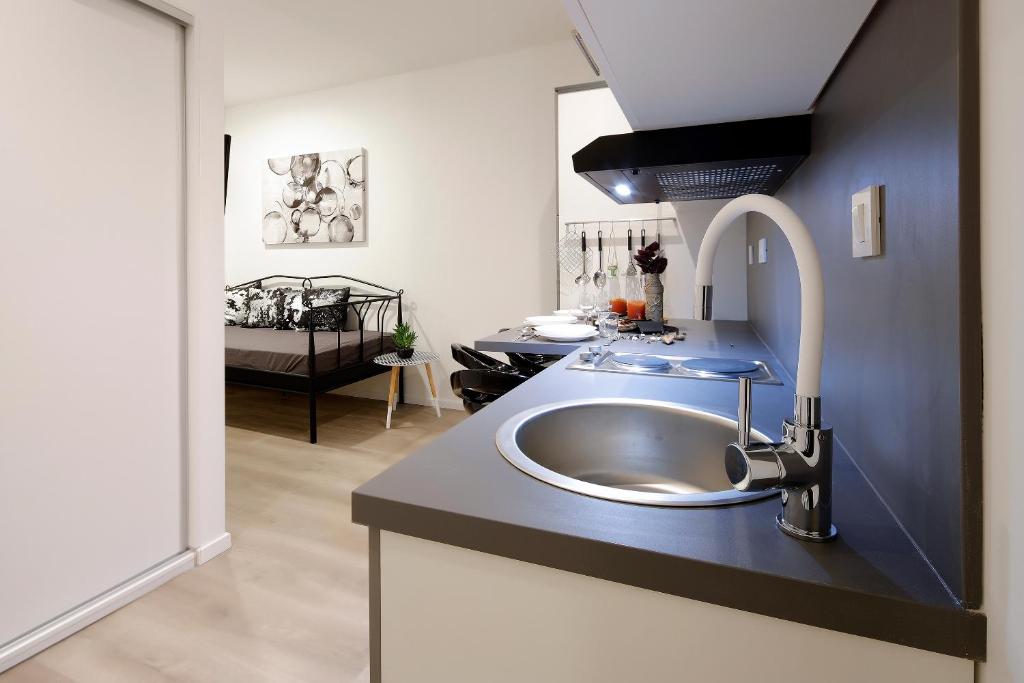a bathroom with a sink in a room at Apartments Zara in Rijeka