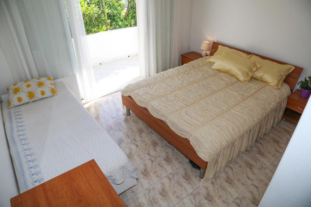 Postel nebo postele na pokoji v ubytování Apartments Butkovic
