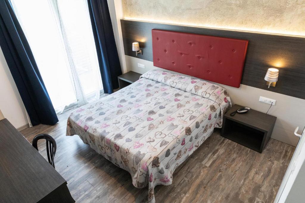Postel nebo postele na pokoji v ubytování Hotel Verdi