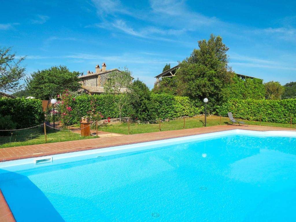 a large blue swimming pool in front of a house at Holiday Home Boriano-4 by Interhome in Lubriano