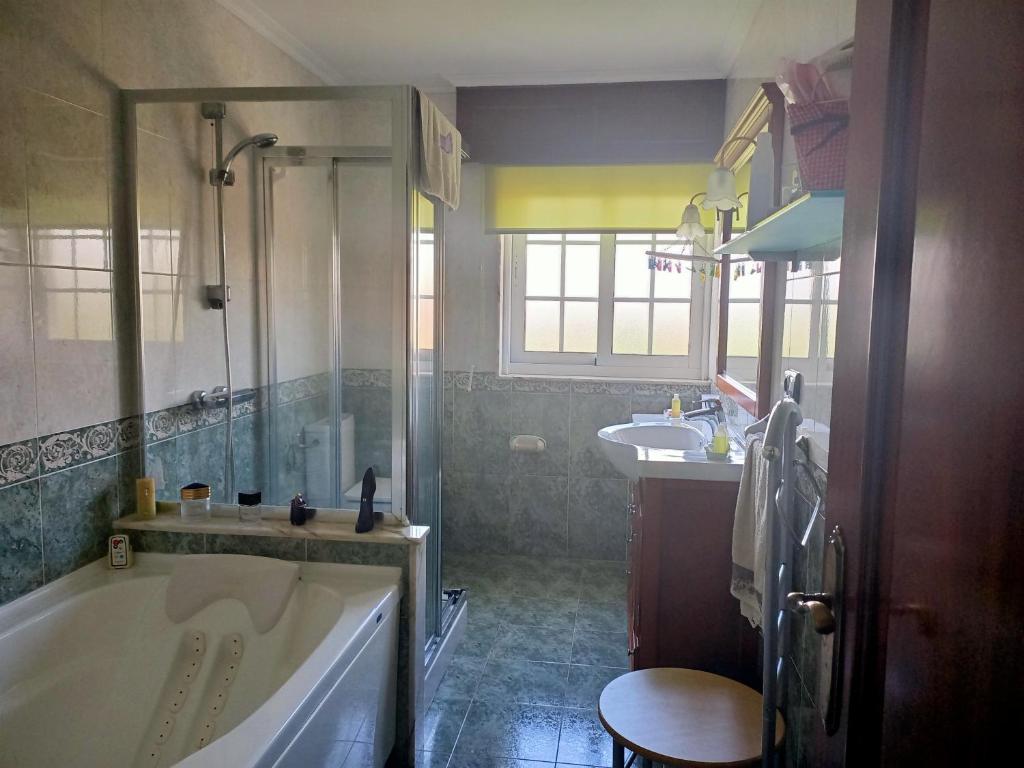 baño con bañera grande y lavamanos en O Seixo 2 en Mugardos