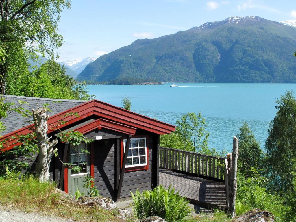 a small cabin with a view of a lake at Chalet Brattland - FJS021 by Interhome in Balestrand
