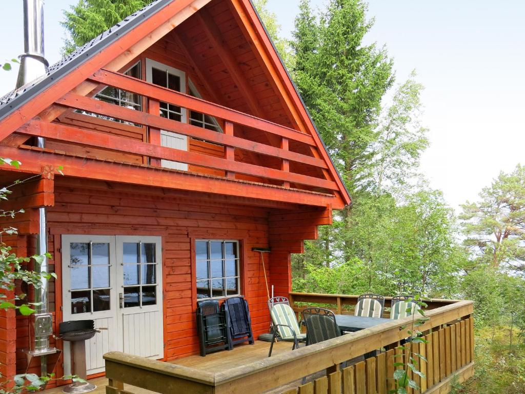 a log cabin with a porch and chairs on a deck at Holiday Home Franz - FJS111 by Interhome in Balestrand