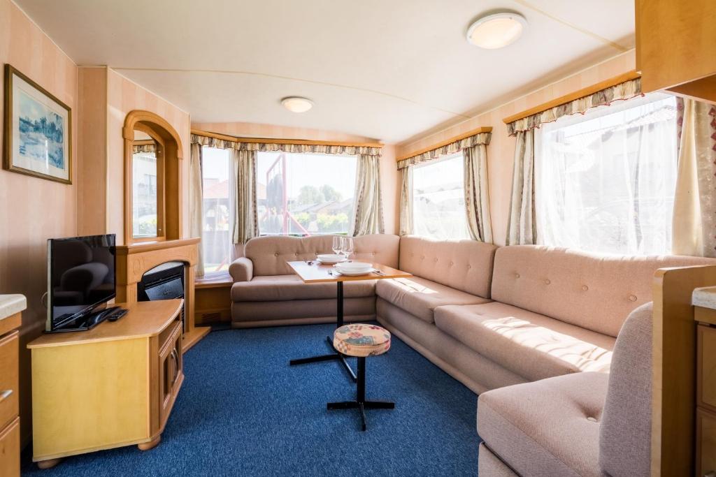 a living room with a couch and a tv at Rowyhills in Rowy