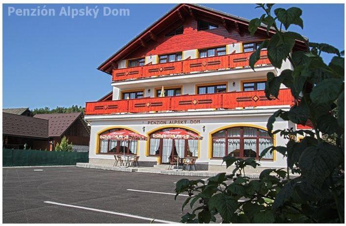 a large building with a parking lot in front of it at Alpský dom Vitanová in Vitanová