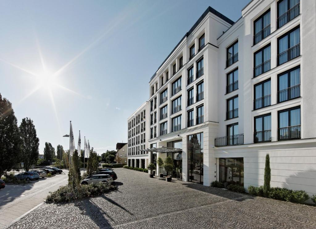 a large white building on a city street at Parkhotel Stuttgart Messe-Airport in Leinfelden-Echterdingen