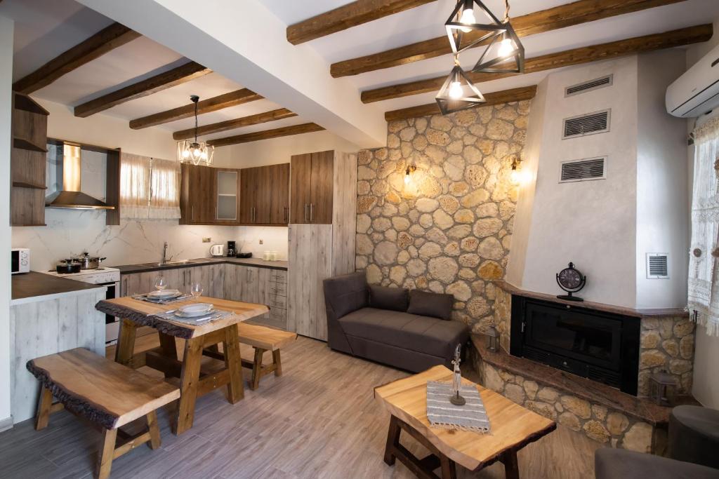 a kitchen and living room with a table and a couch at Stone Villa Hermione in Kariá