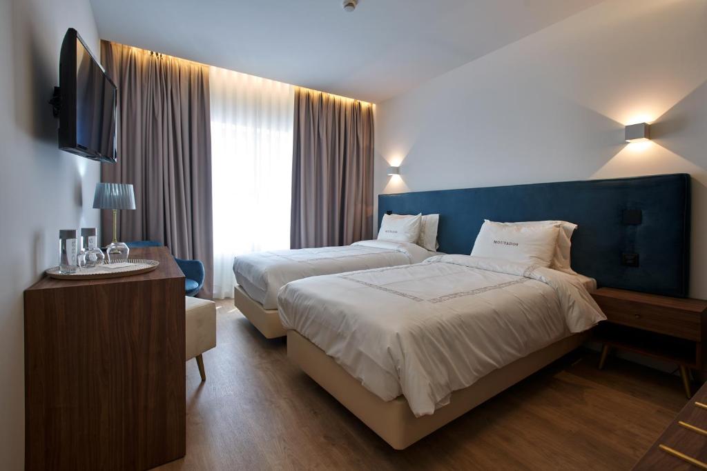 Postel nebo postele na pokoji v ubytování Hotel Moutados