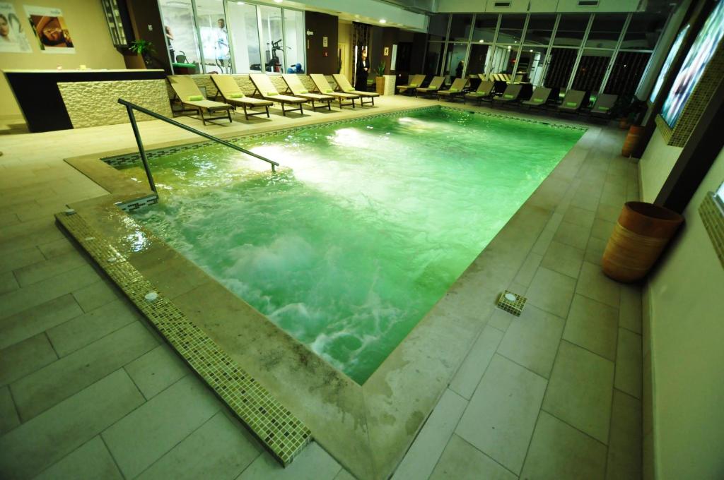 a jacuzzi tub with chairs in a hotel room at Hotel Royal Spa in Banja Koviljača