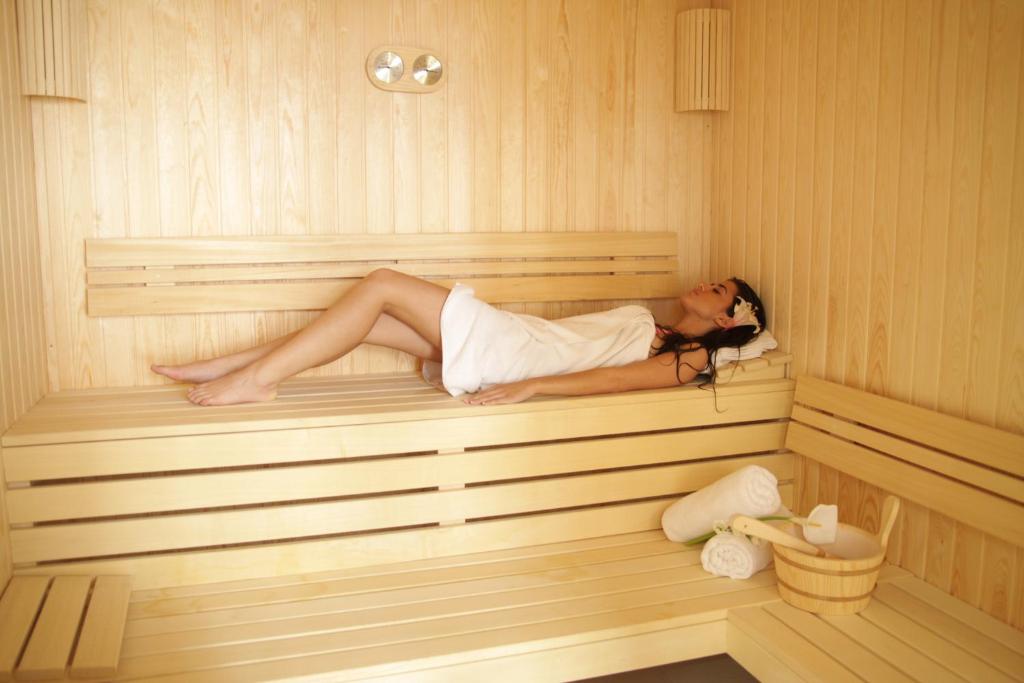 a woman is laying in a sauna at Hotel Royal Spa in Banja Koviljača