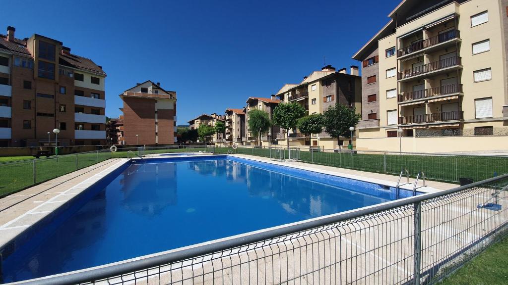 a large swimming pool on the side of a building at Apartamento Naturaleza 2000 Jaca 1º in Jaca